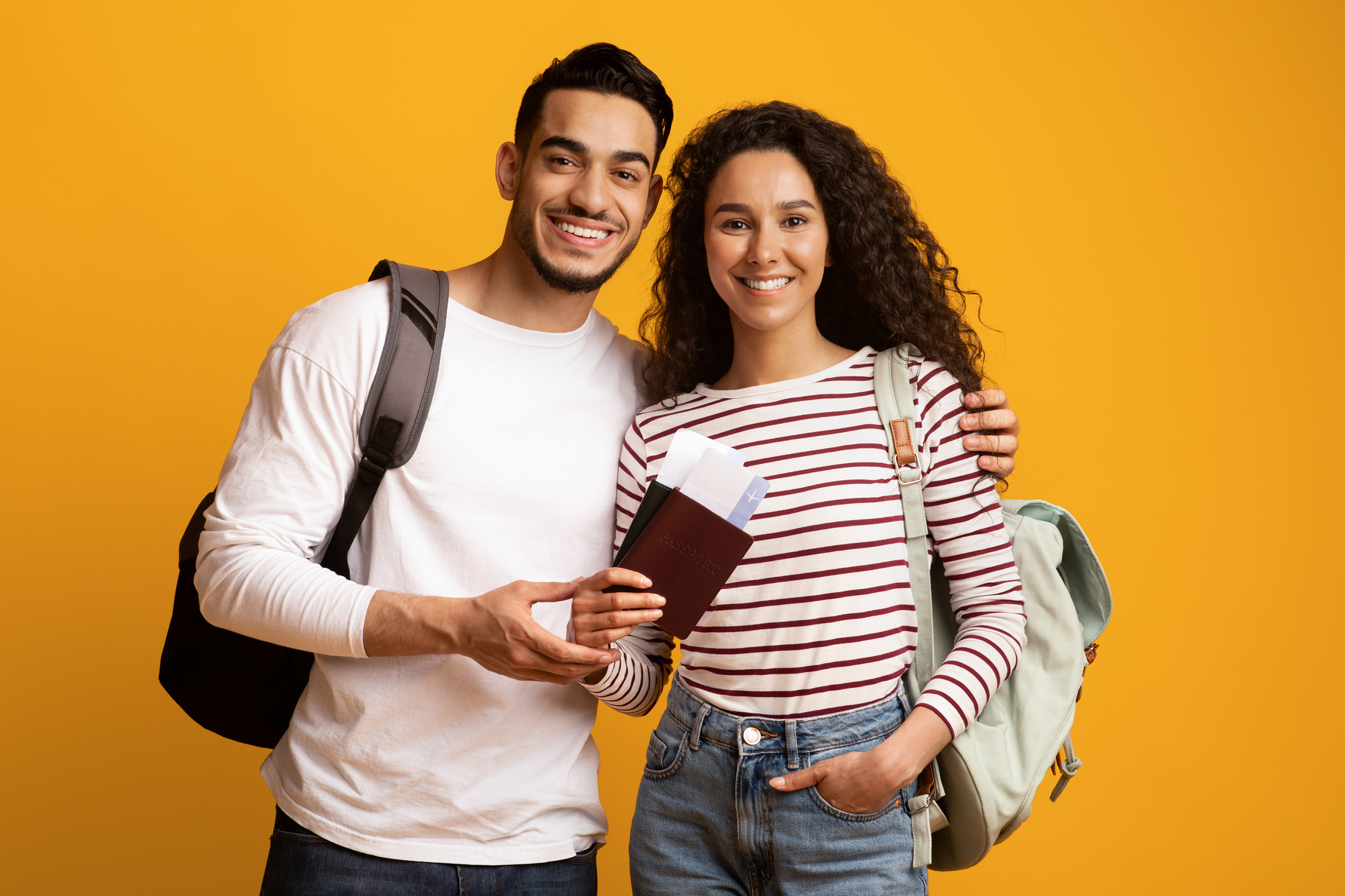 Happy Travellers. Smiling Arab Couple with Backpacks, Passports and Travel Tickets